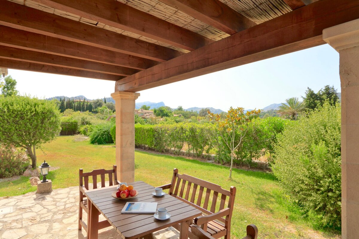 A wooden table with a bowl of fruit on it