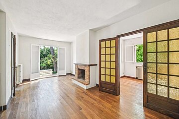 A living room with a fireplace and stained glass doors