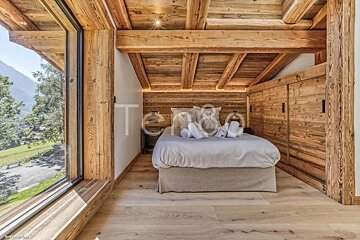 A bedroom with a bed and a window with the word tersol on the bottom