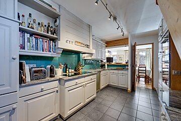 A kitchen with white cabinets and a toaster that says ' nespresso ' on it