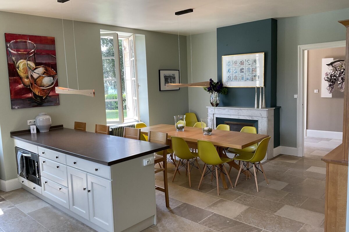 A kitchen with a table and chairs and a fireplace