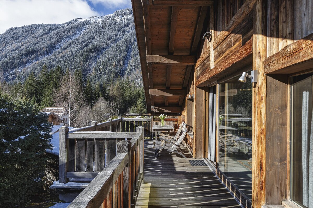 A wooden deck with a mountain in the background