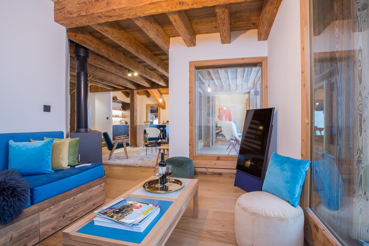A living room with a blue couch and blue pillows
