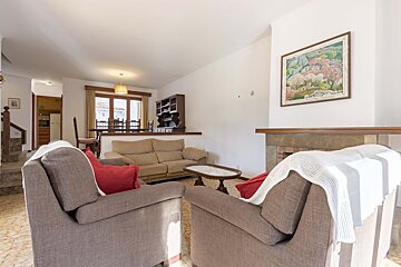 A living room with a couch and two chairs