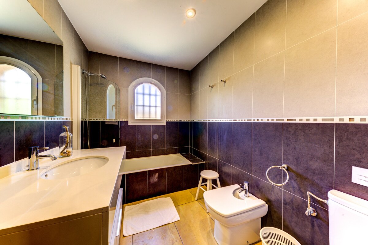 A bathroom with a sink toilet and bathtub