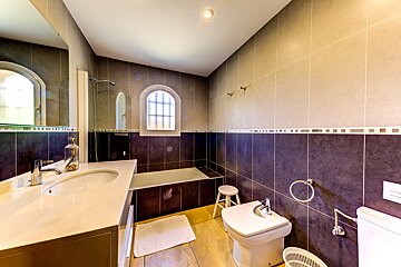 A bathroom with a sink toilet and bathtub