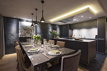 A dining room table with plates and utensils on it