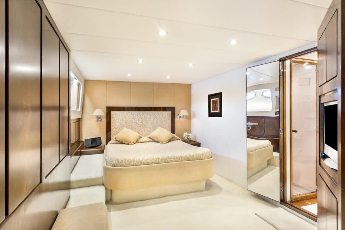 A bedroom with a large bed and a mirror