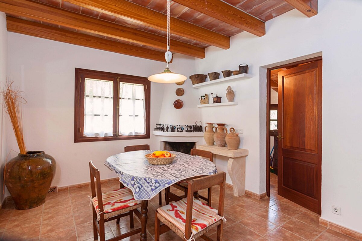 A dining room with a table and chairs and a fireplace
