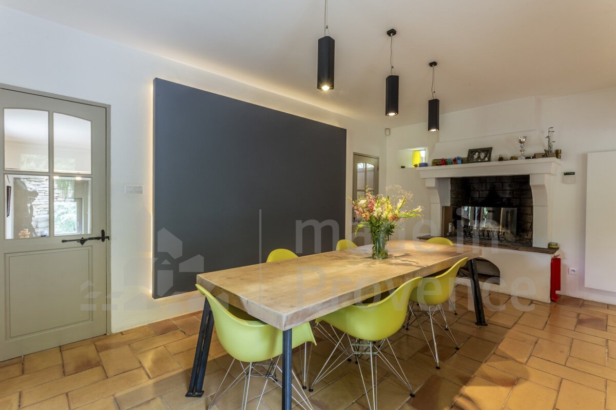 A dining room with a table and chairs and the word france on the wall