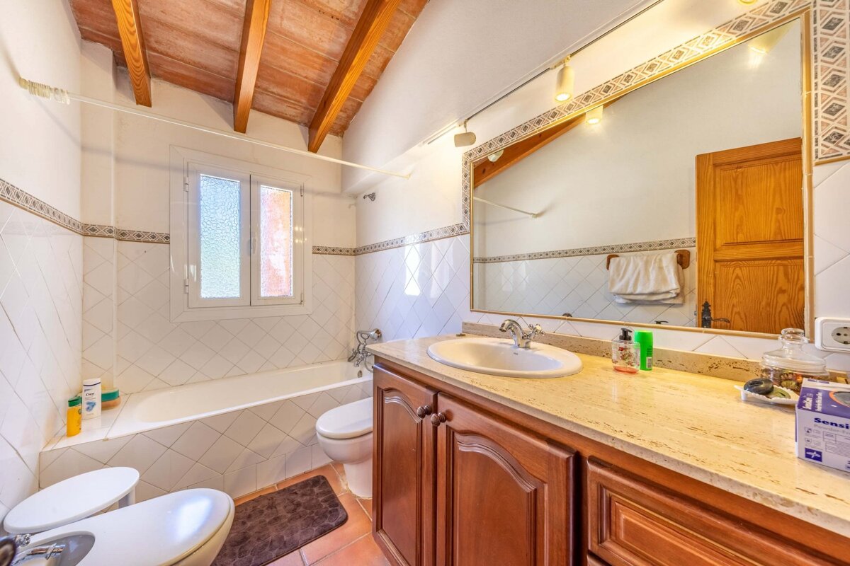 A bathroom with a toilet a sink and a bathtub