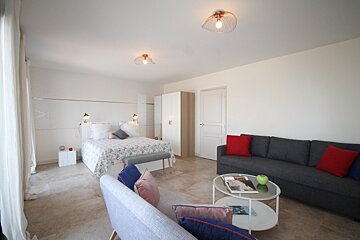 A living room with a couch and a bed
