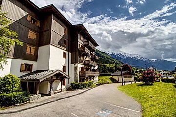 A large building with mountains in the background