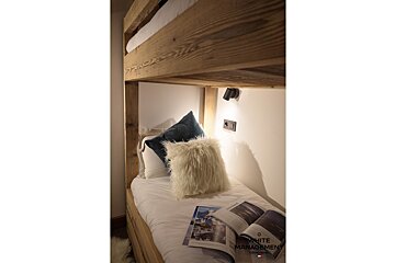 A large house with a balcony and a satellite dish on the roof