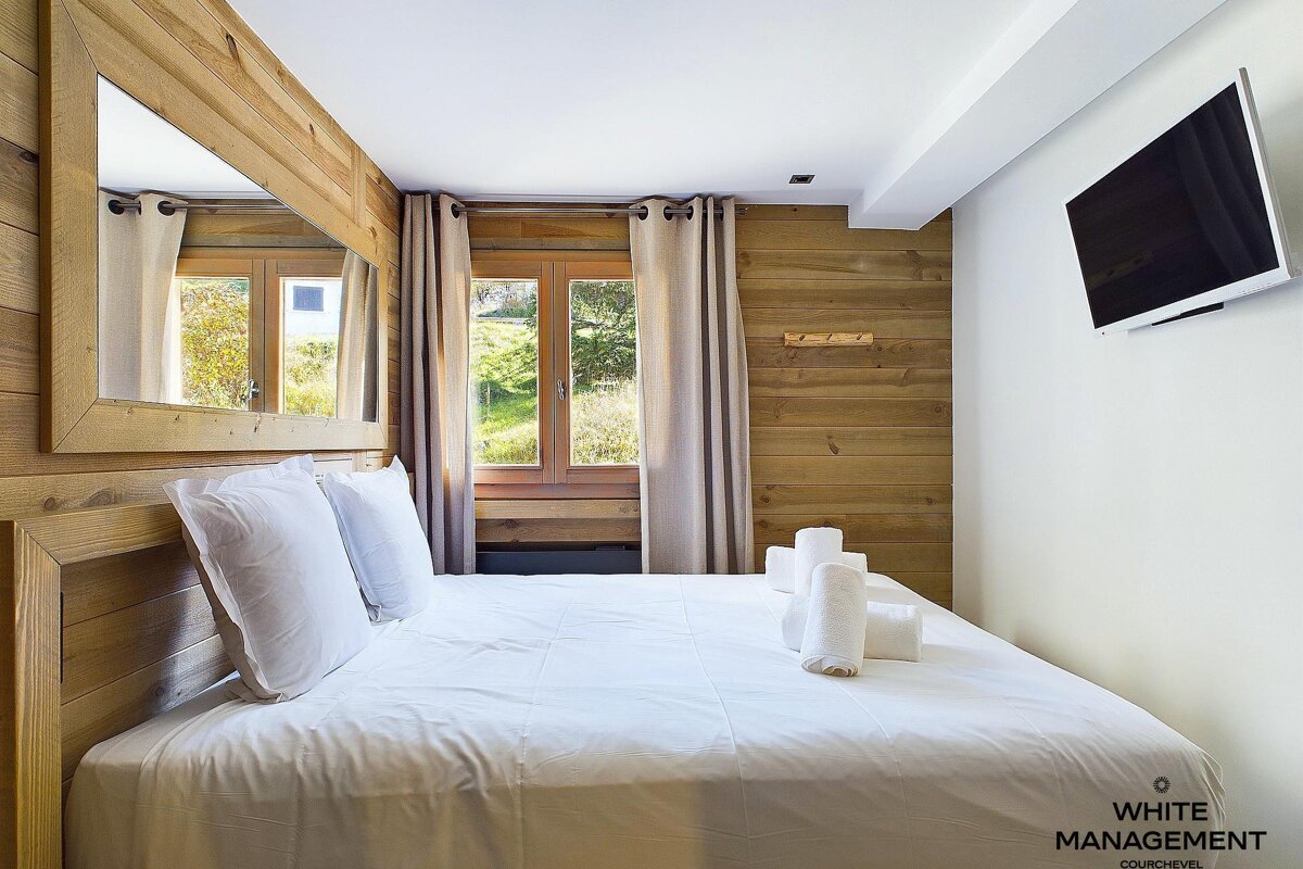 A kitchen with wood paneling and a picture on the wall
