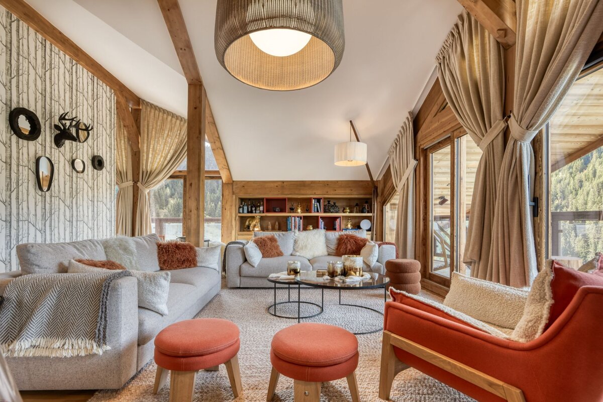 A living room with a couch and chairs and a table