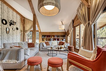 A living room with a couch and chairs and a table