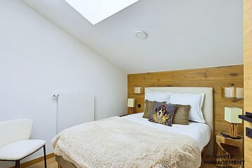 A bedroom with white management written on the door