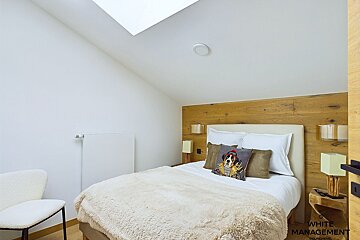 A bedroom with white management written on the door