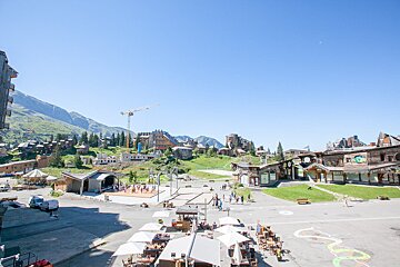 An aerial view of a city with mountains in the background