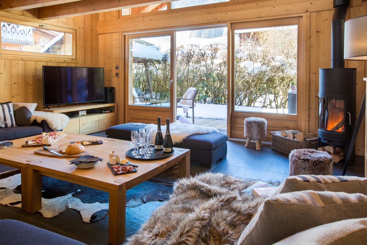 A living room with a fireplace and a flat screen tv