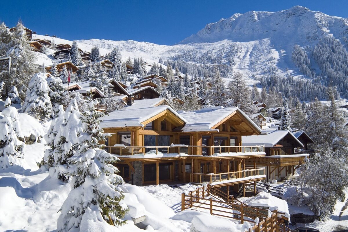 A snowy landscape with a mountain in the background