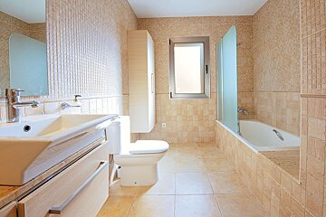 A bathroom with a sink toilet and bathtub