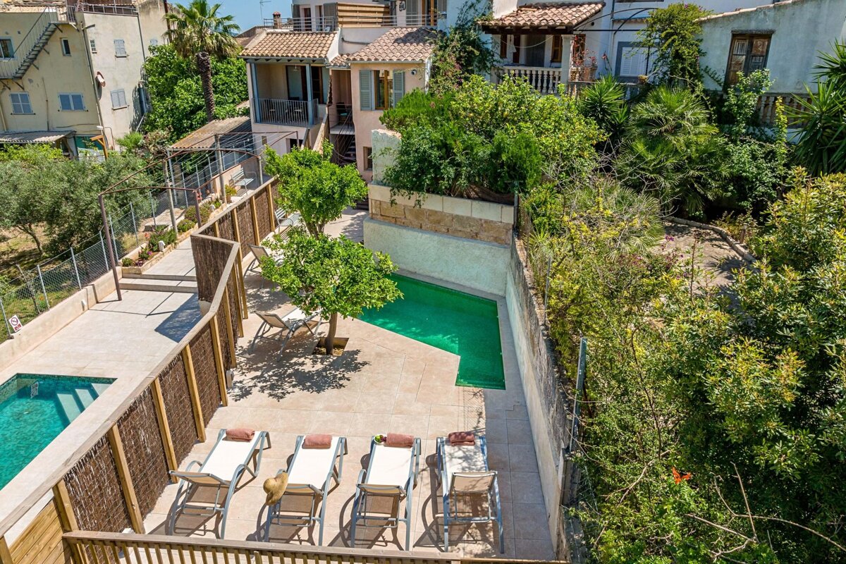 An aerial view of a house with a swimming pool