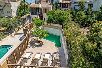 An aerial view of a house with a swimming pool