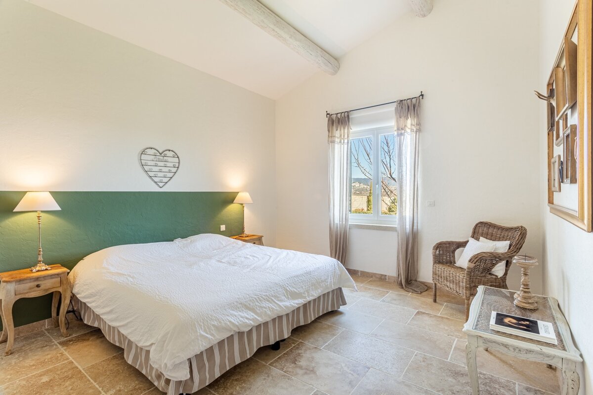 A bedroom with a bed and a heart on the wall
