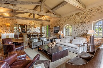 A living room with a couch and two chairs