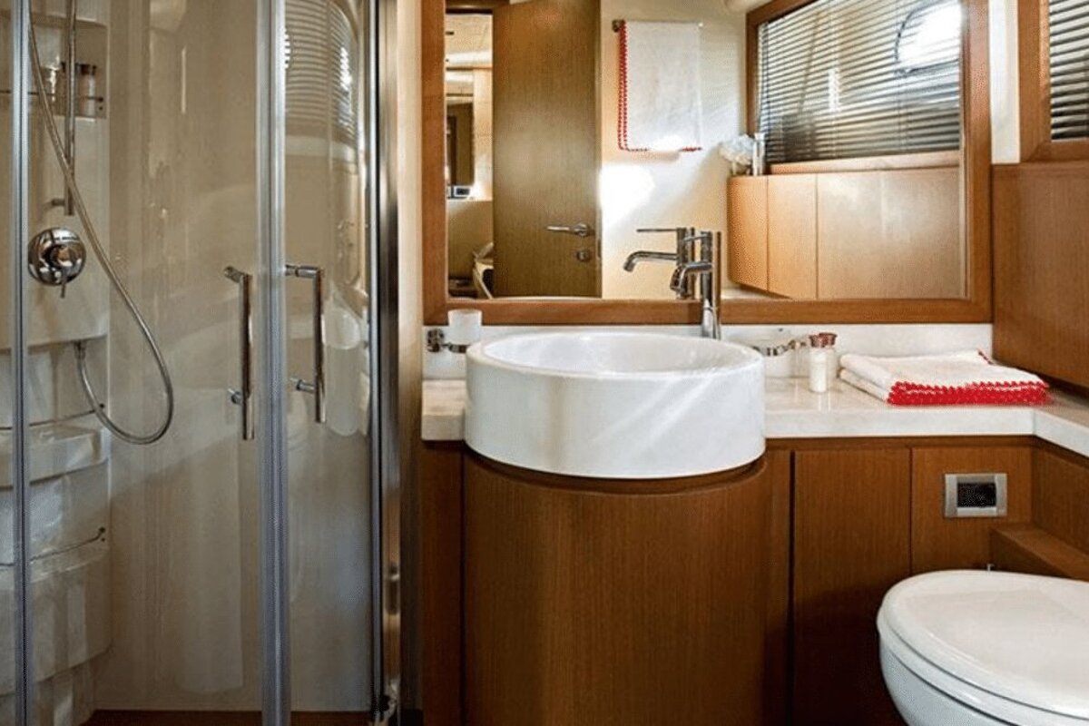 A bathroom with a toilet a sink and a shower