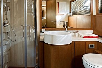 A bathroom with a toilet a sink and a shower