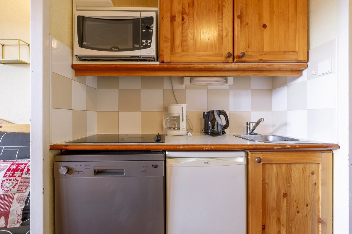 A living room with a red couch and a table