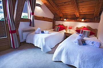 A hotel room with two beds and a sign that says ' swiss ' on it