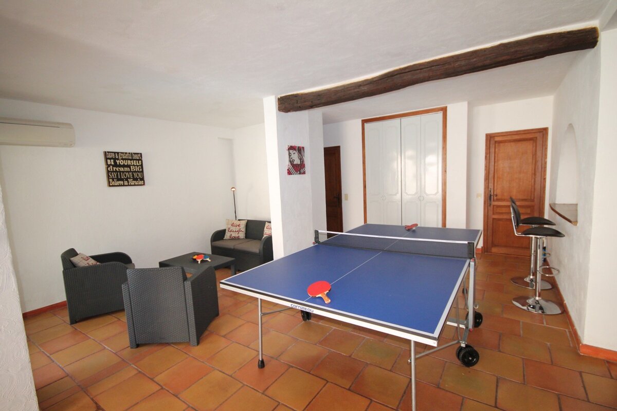 A room with two ping pong tables and a sign that says 