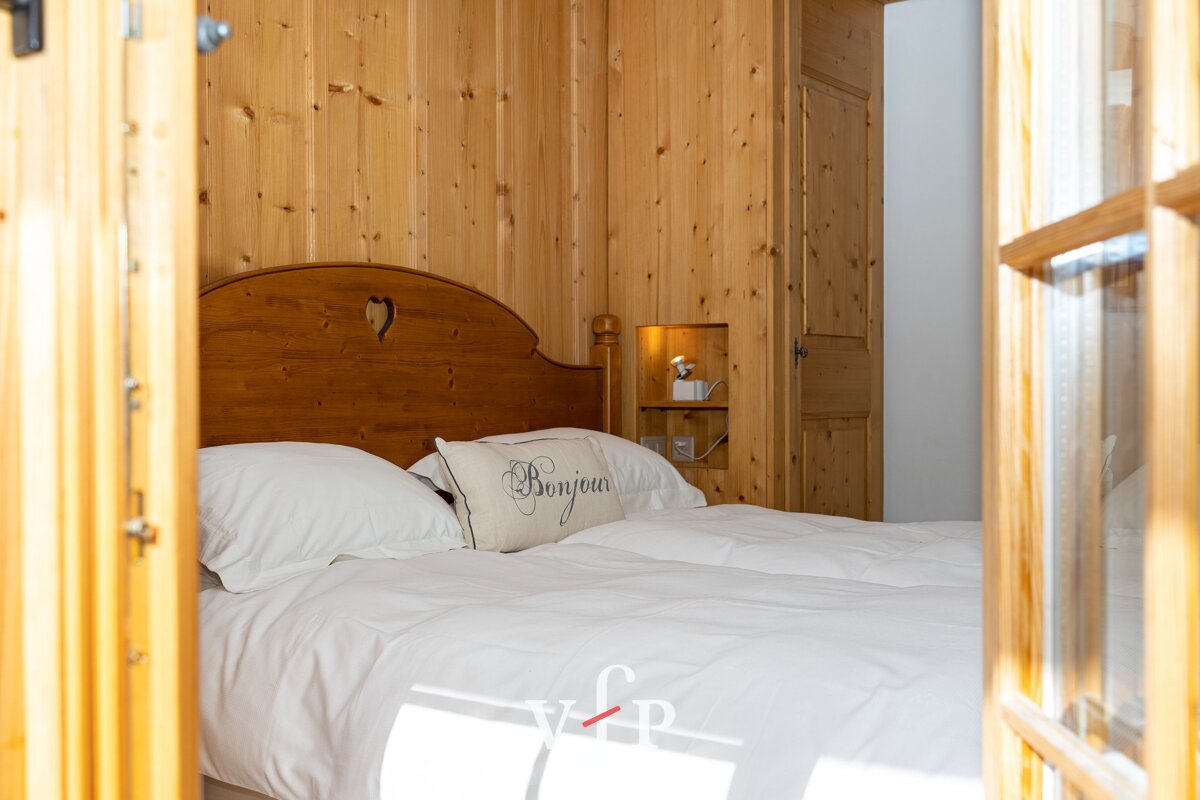 A bed with a pillow that says bonjour on it