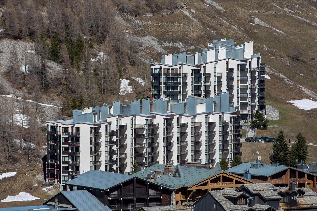 A snowy building with a blue sky in the background
