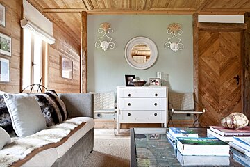 A living room with a couch and a dresser