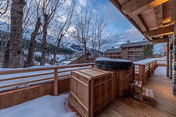 A wooden deck with a hot tub on it