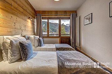 A bedroom with two beds and a sign that says mountain base