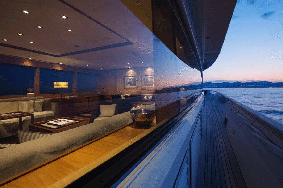 A living room with a view of the ocean and mountains