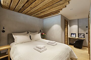 A bedroom with a bed and two towels on it