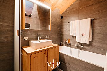 A bathroom with a sink and a bathtub with the letters vfp on the bottom