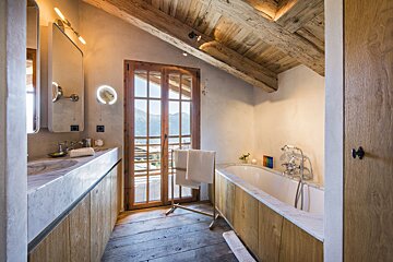 A bathroom with a bathtub a sink and a mirror