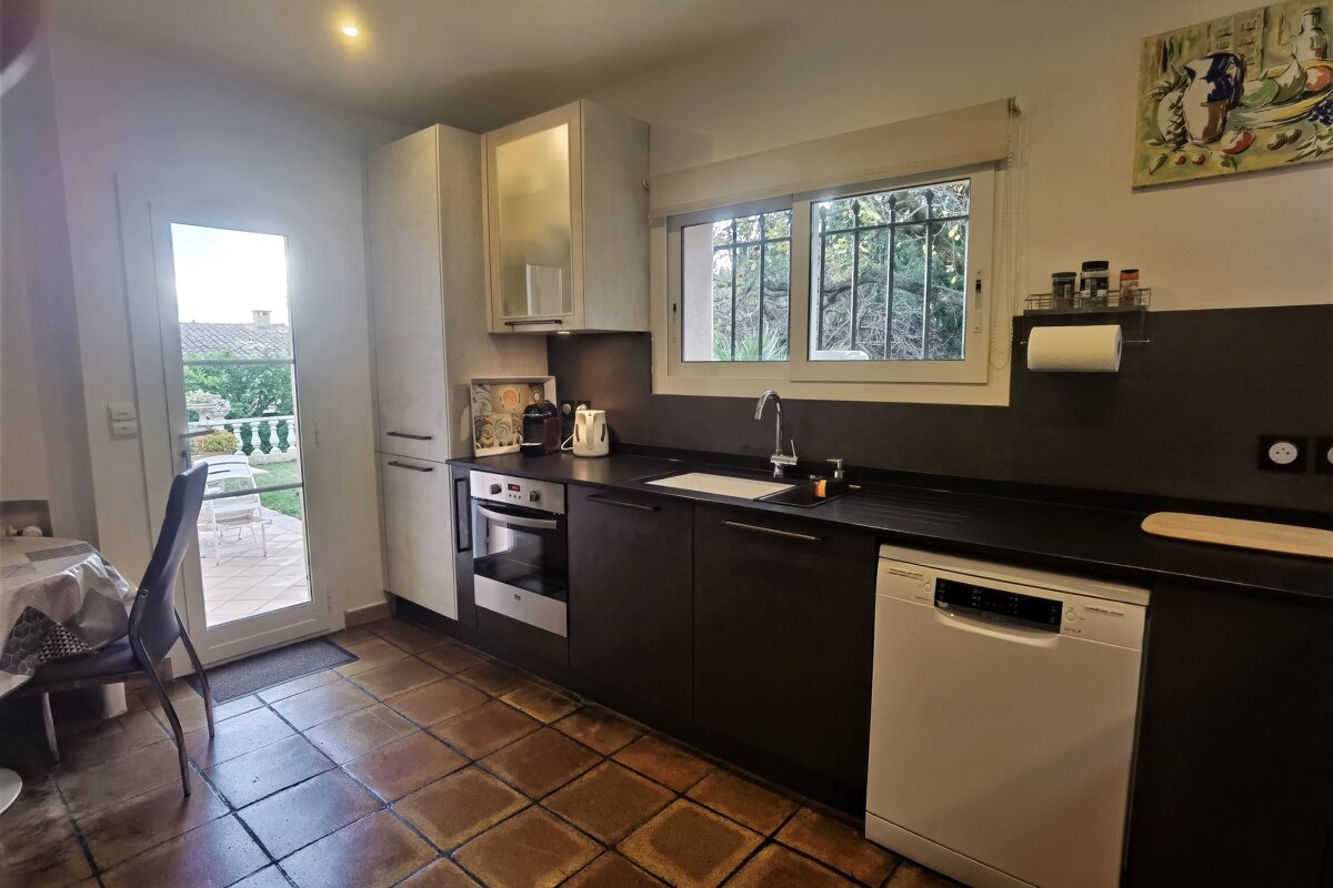 A kitchen with black cabinets and a bosch dishwasher