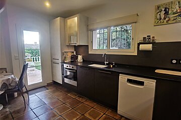 A kitchen with black cabinets and a bosch dishwasher