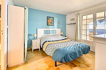 A bedroom with a blue wall and a bed