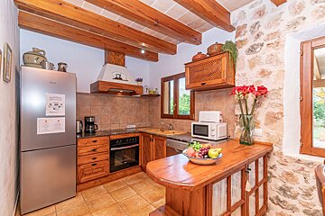 A kitchen with a siemens refrigerator and a microwave