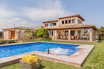 A large house with a swimming pool in front of it